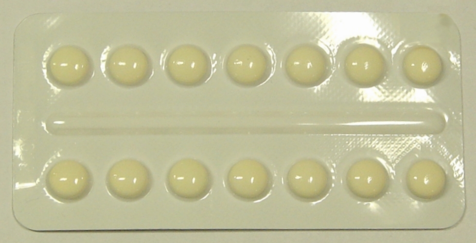 Photograph of a blister pack containing small yellow tablets.